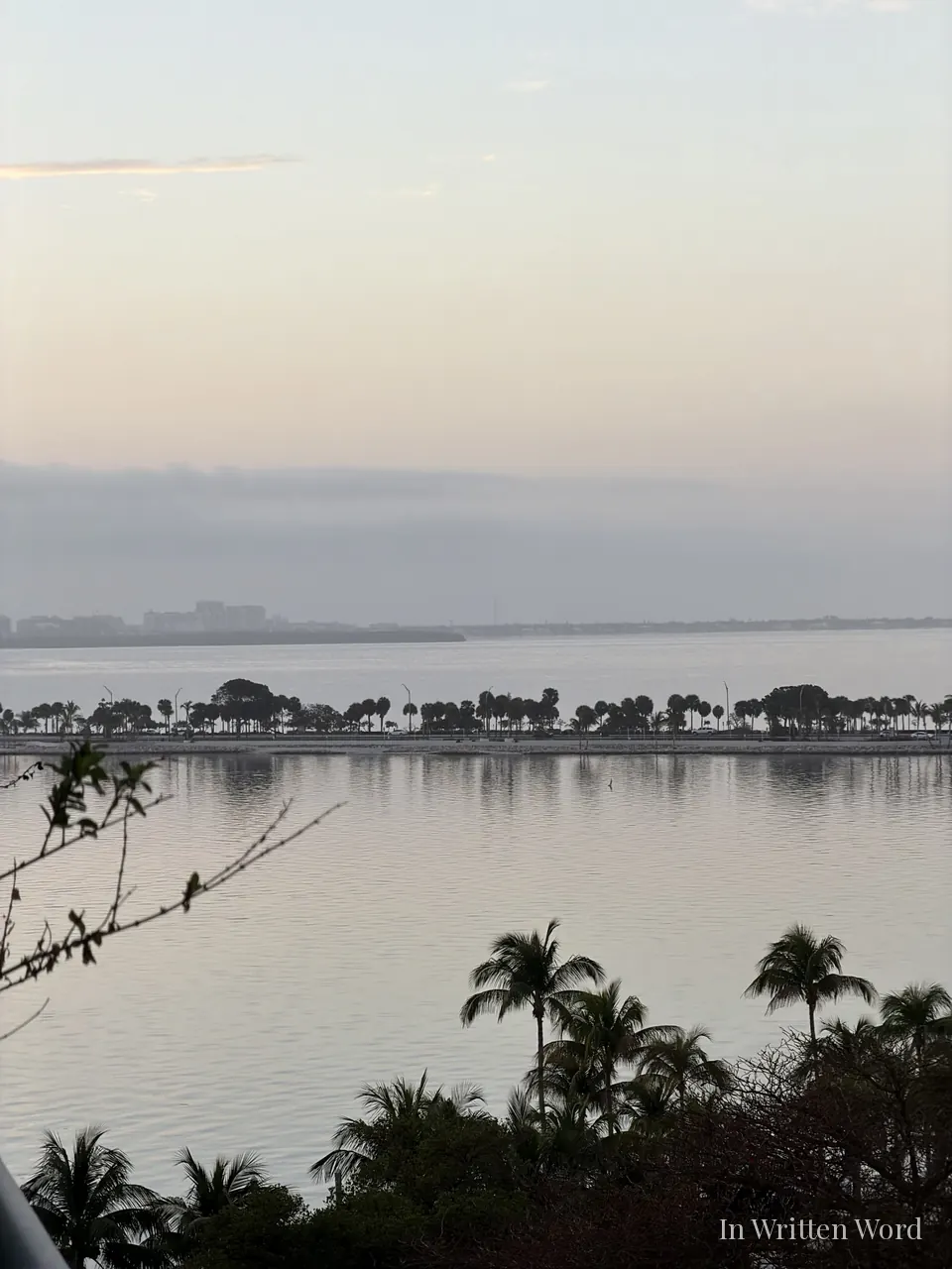 Calm bay at sunrise in Miami with soft pastel sky and still water reflecting early morning light